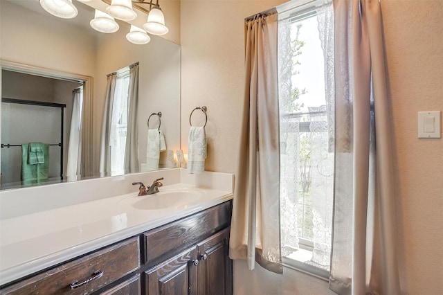 bathroom featuring an inviting chandelier and vanity
