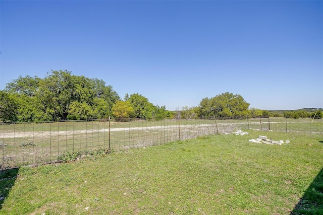 view of yard featuring fence and a rural view