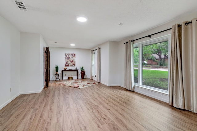1806 Elm Crest Dr, Arlington, TX 76012 - unfurnished living room featuring light wood-type flooring, baseboards, and recessed lighting