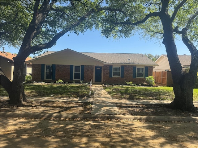 single story home with fence and brick siding
