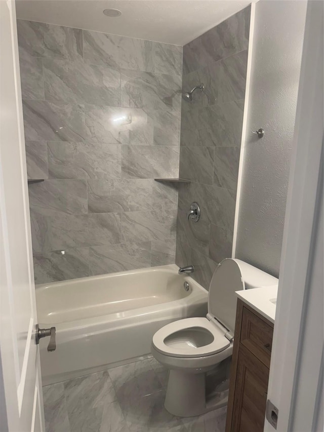full bath with washtub / shower combination, toilet, vanity, and marble finish floor