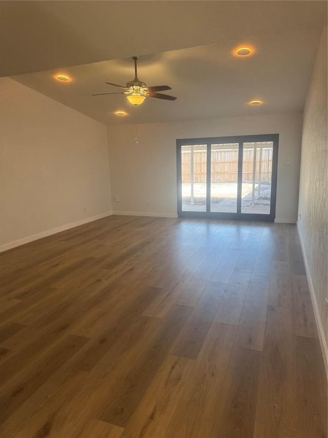 empty room featuring recessed lighting, baseboards, a ceiling fan, and dark wood finished floors
