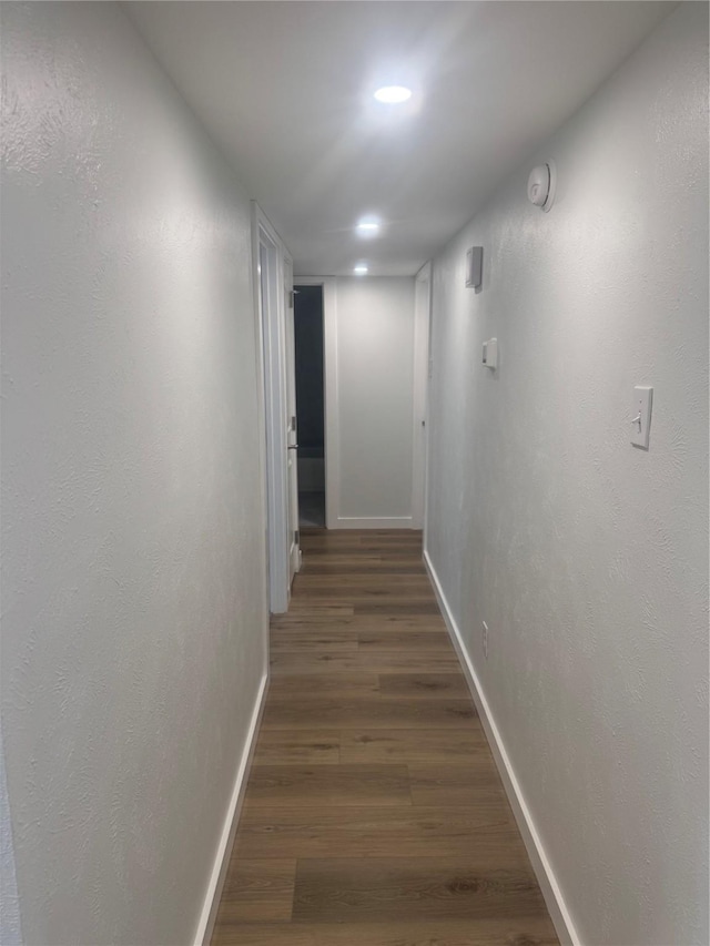 hallway with recessed lighting, baseboards, and wood finished floors