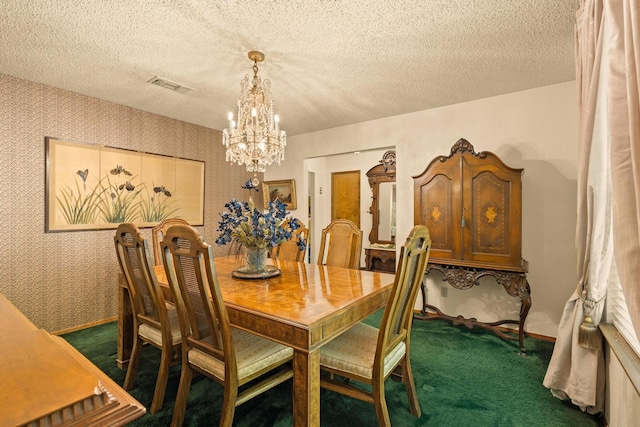 dining area featuring dark colored carpet, a textured ceiling, visible vents, a notable chandelier, and wallpapered walls