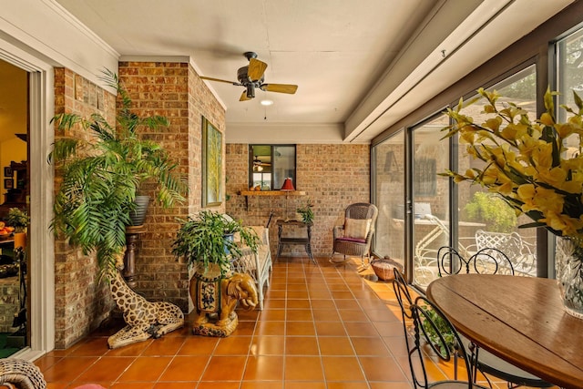 sunroom / solarium with brick wall and tile patterned floors