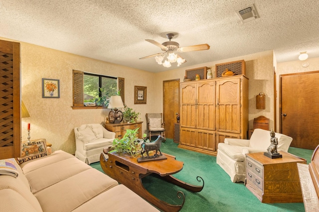 living room with a ceiling fan, a textured ceiling, visible vents, and carpet