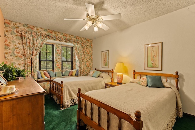 bedroom featuring dark colored carpet, a textured ceiling, and ceiling fan