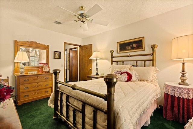 bedroom featuring dark colored carpet, visible vents, a textured ceiling, and ceiling fan
