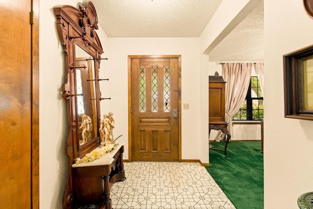 entryway featuring baseboards and a textured ceiling
