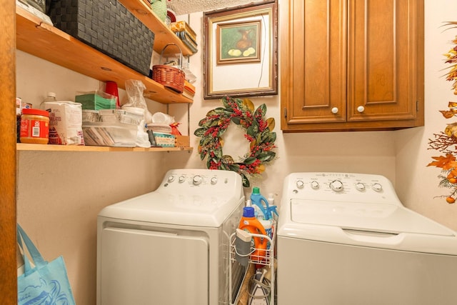 laundry room with washing machine and dryer and cabinet space