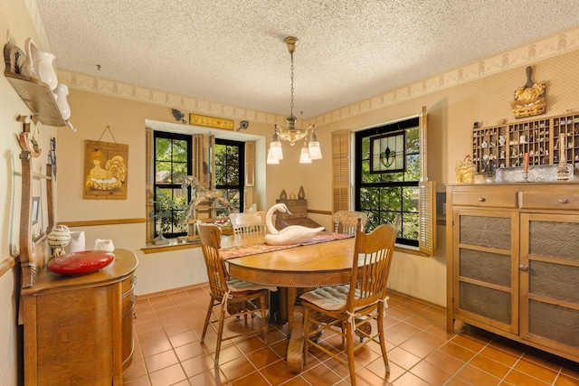 dining space with wallpapered walls, a wealth of natural light, tile patterned flooring, and a textured ceiling
