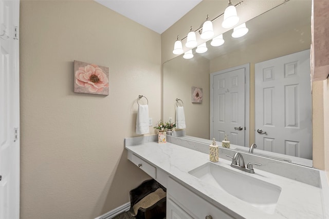 bathroom with baseboards and vanity