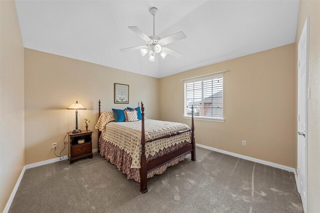 carpeted bedroom with ceiling fan and baseboards