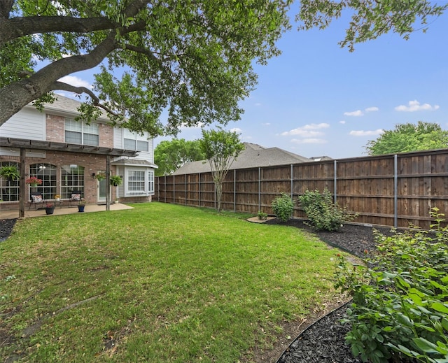 view of yard featuring a patio area and a fenced backyard