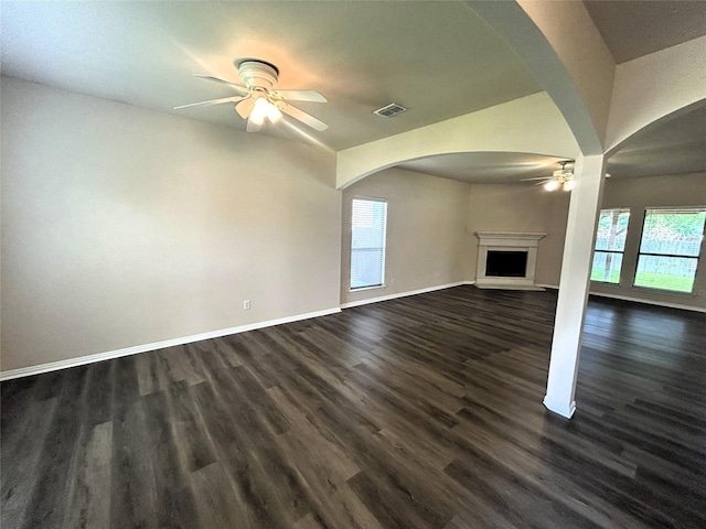 4303 Grassy Glen Dr, Corinth, TX 76208 - unfurnished living room featuring ceiling fan, healthy amount of natural light, a fireplace with raised hearth, and baseboards