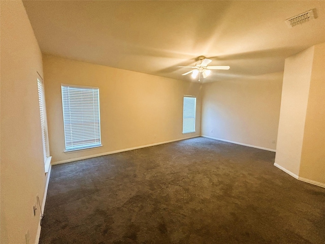 4303 Grassy Glen Dr, Corinth, TX 76208 - spare room featuring dark colored carpet, ceiling fan, and baseboards