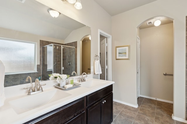 601 Wichita Trl, Mckinney, TX 75071 - full bathroom featuring double vanity, a shower stall, lofted ceiling, and a sink