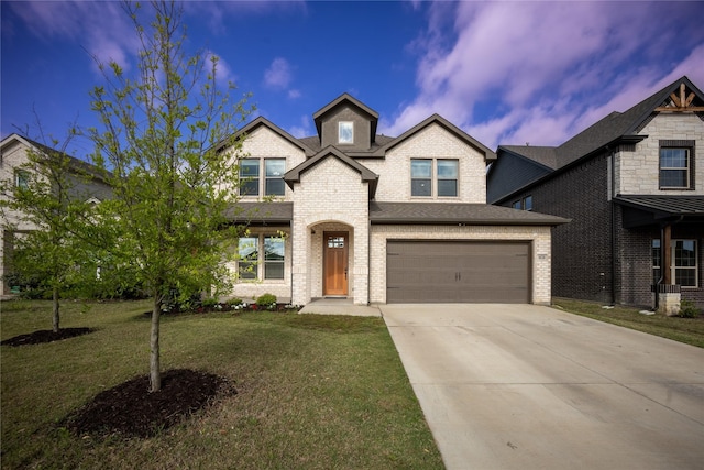 view of front of home with roof with shingles, a front lawn, concrete driveway, brick siding, and an attached garage