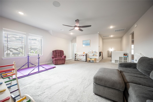 living room featuring carpet, visible vents, ceiling fan, and a healthy amount of sunlight