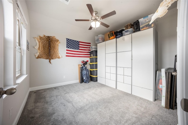 unfurnished bedroom with carpet flooring, baseboards, and ceiling fan