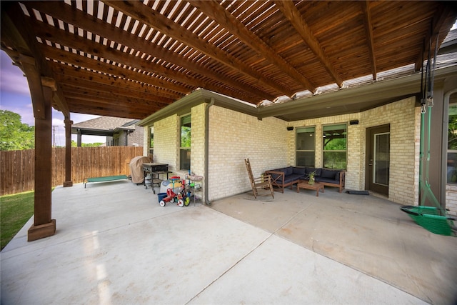 view of patio featuring fence, a pergola, and an outdoor hangout area