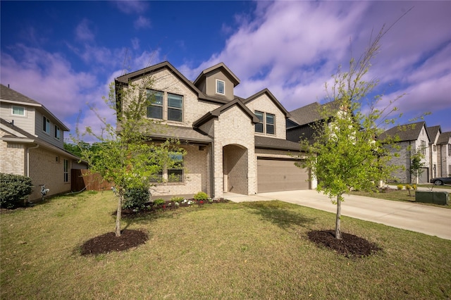 traditional-style home featuring brick siding, an attached garage, a front yard, and concrete driveway