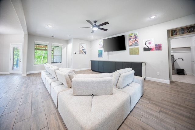 living area featuring recessed lighting, wood finished floors, baseboards, and ceiling fan
