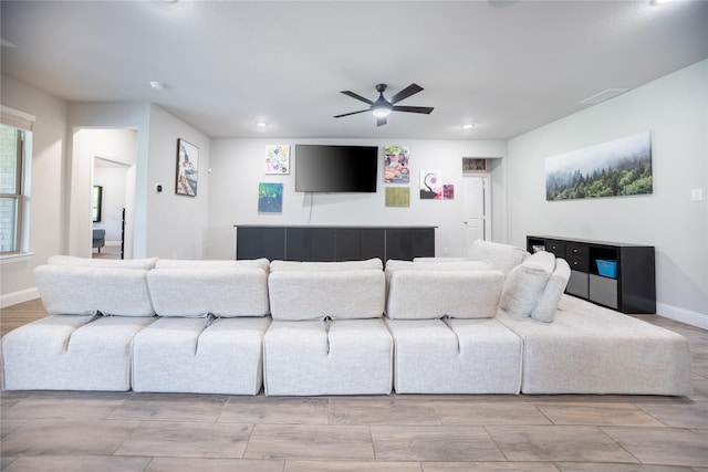 living area with recessed lighting, visible vents, baseboards, wood finish floors, and ceiling fan