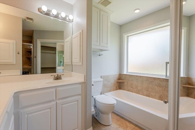 bathroom featuring a garden tub, toilet, vanity, and visible vents