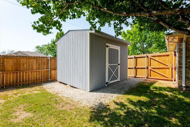 view of shed with a gate and a fenced backyard