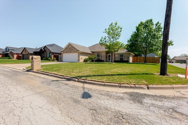 single story home with fence, a residential view, an attached garage, driveway, and a front yard