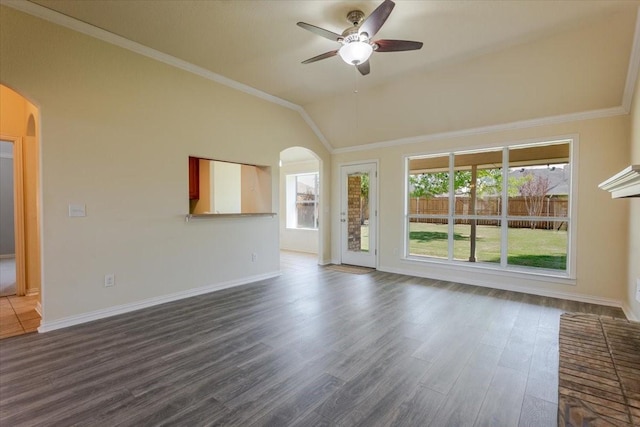 unfurnished living room featuring arched walkways, baseboards, dark wood-style floors, and ceiling fan