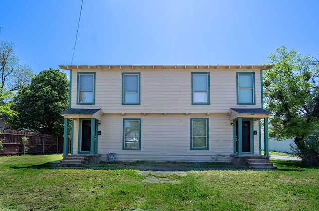 view of front of property featuring fence and a front yard