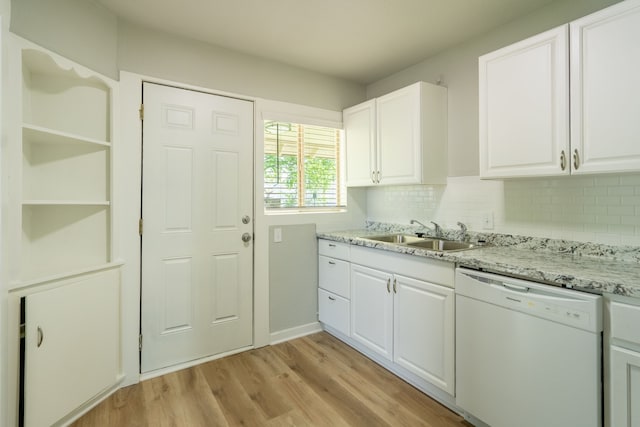 kitchen featuring a sink, decorative backsplash, light wood-style floors, dishwasher, and white cabinetry