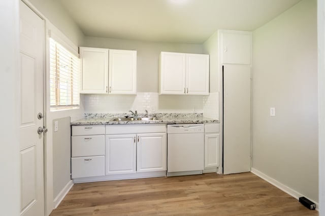 kitchen featuring dishwasher, white cabinetry, decorative backsplash, and a sink