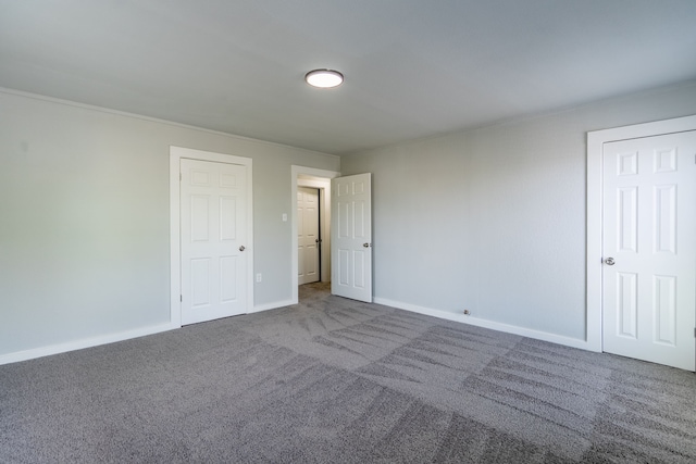 unfurnished bedroom with baseboards and carpet flooring