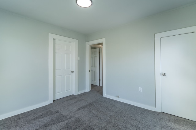 unfurnished bedroom featuring baseboards and carpet