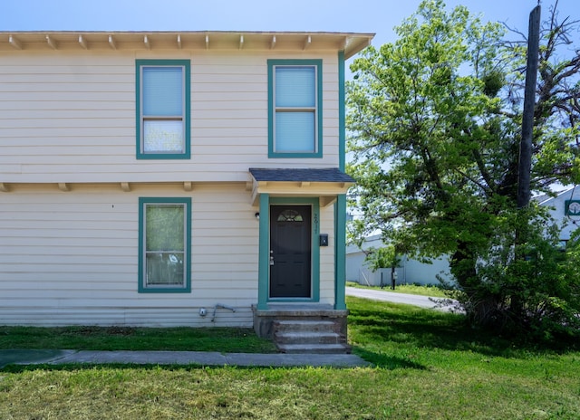 view of front of house featuring entry steps and a front yard