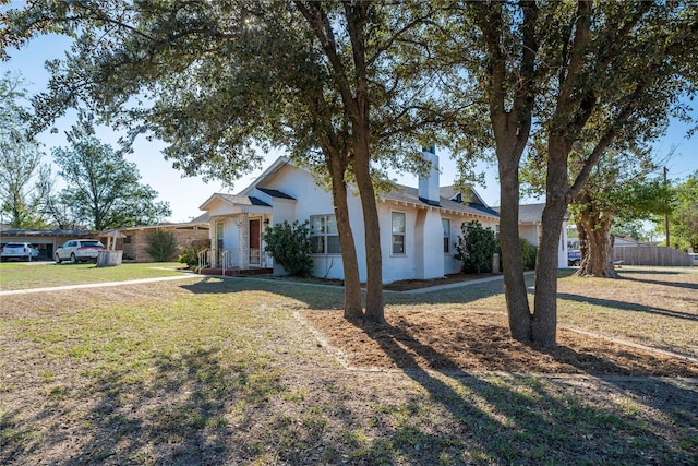 602 E Beauregard St, Rotan, TX 79546 - view of front of house with a chimney, a front yard, and fence