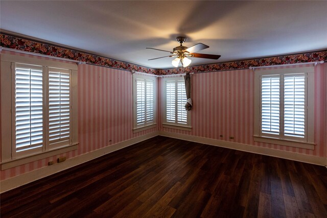 602 E Beauregard St, Rotan, TX 79546 - spare room featuring baseboards, a ceiling fan, and wood finished floors