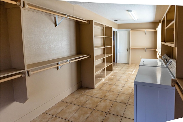 602 E Beauregard St, Rotan, TX 79546 - laundry room featuring washing machine and clothes dryer, laundry area, and light tile patterned floors