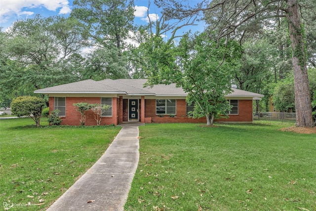 ranch-style house with brick siding, a front lawn, and fence