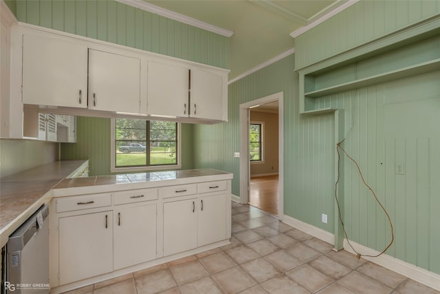 kitchen with light countertops, dishwasher, crown molding, and white cabinets