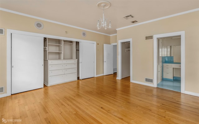 unfurnished bedroom with visible vents, a chandelier, and ornamental molding