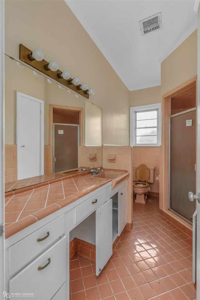 bathroom with tile walls, visible vents, tile patterned flooring, and a stall shower