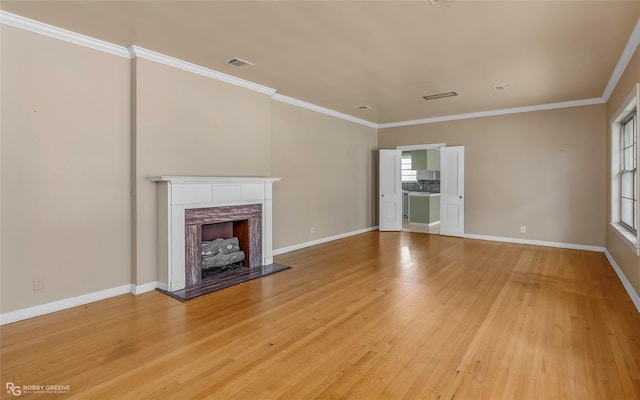 unfurnished living room featuring a fireplace, visible vents, light wood finished floors, and baseboards