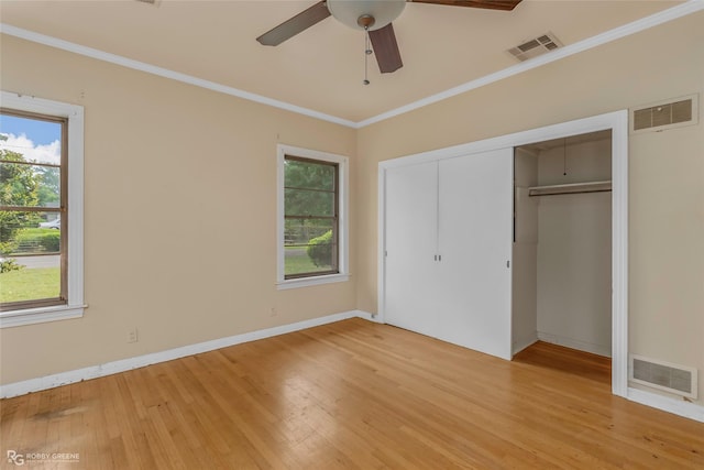 unfurnished bedroom featuring multiple windows, visible vents, and light wood-type flooring