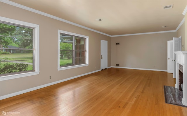 unfurnished living room featuring plenty of natural light, light wood-style flooring, and visible vents