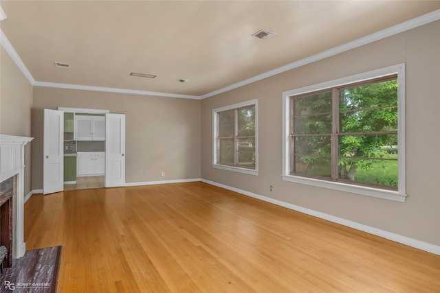 unfurnished living room with light wood-type flooring, baseboards, visible vents, and a fireplace
