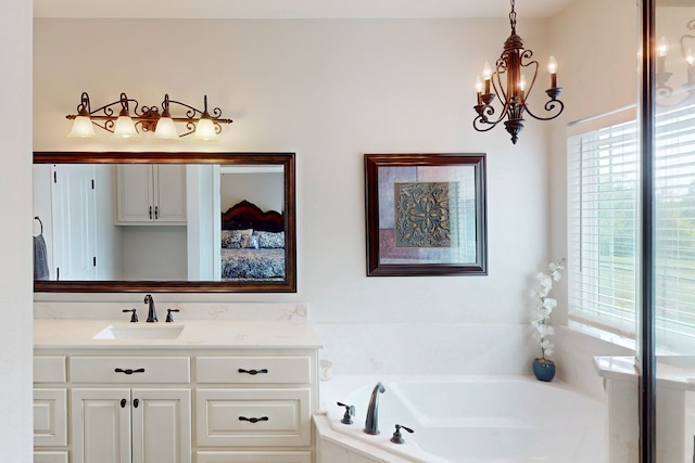 full bath with a garden tub, vanity, and a notable chandelier
